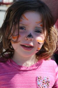 young girl with tiger face paint at 2nd annual community celebration