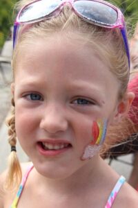 young girl with face paint at 2nd annual community celebration