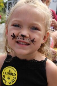 young girl with face paint at 2nd annual community celebration