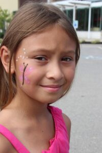 young girl with face paint at 2nd annual community celebration