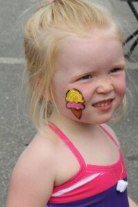 young girl with ice cream face paint at 2nd annual community celebration