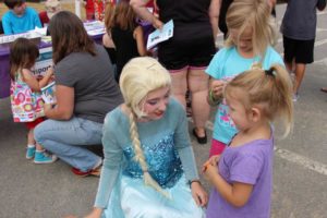 elsa and two young girls at 2nd annual community celebration