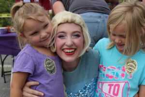 elsa and two young girls at 2nd annual community celebration