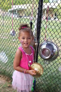 young girl paying cymbals at 2nd annual community celebration