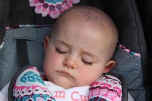 baby napping in stroller at 2nd annual community celebration