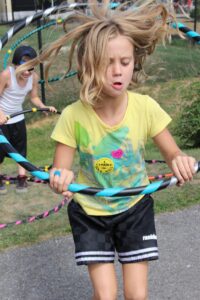 young girl playing with hula hoop at 2nd annual community celebration