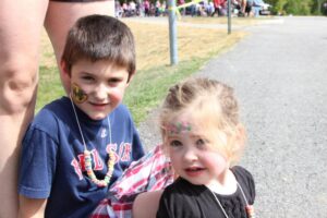 two young children with face paint at 2nd annual community celebration