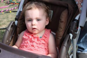 baby girl in stroller at 2nd annual community celebration