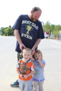 dad with two young children at 2nd annual community celebration