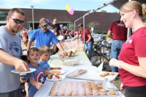 volunteers handing out lunch at 2nd annual community celebration