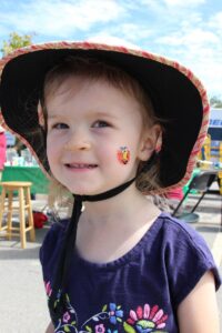 young girl smiling at 2nd annual community celebration