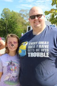 man and young girl with face paint at 2nd annual community celebration