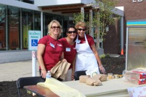 three women volunteers at 2nd annual community celebration