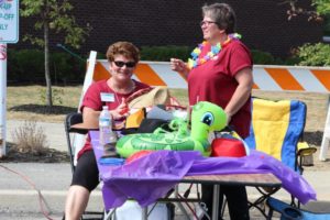two volunteers at table at 2nd annual community celebration