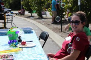 woman volunteer with bubbles at 2nd annual community celebration