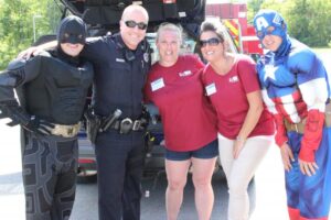 captain america batman police officer and two women at 2nd annual community celebration