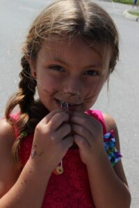 young girl in face paint with 2nd annual community celebration