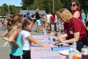 young girls getting stickers at 2nd annual community celebration