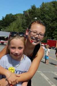 two girls with face paint at 2nd annual community celebration