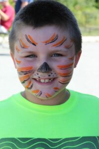 boy with tiger face paint at 2nd annual community celebration