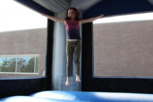 young girl in bounce house at 2nd annual community celebration