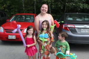 group of kids with their balloon flowers at 2nd annual community celebration