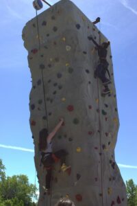 kids climbing the climbing wall at 3rd annual community celebration