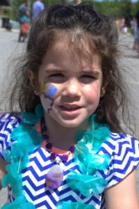 young girl with face paint at 3rd annual community celebration