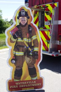 kid in waterville fire department cutout at 3rd annual community celebration