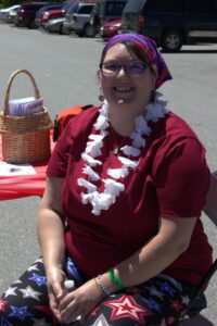 woman smiling at 3rd annual community celebration