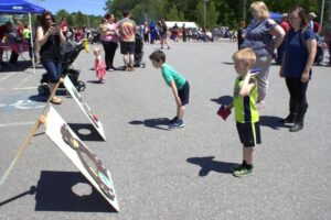 kids playing bean bag toss at 3rd annual community celebration