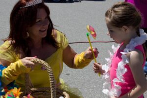 belle handing out pinwheel at 3rd annual community celebration