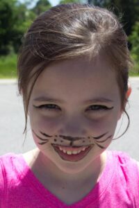 young girl with cat face paint at 3rd annual community celebration