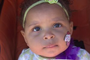 baby with face paint at 3rd annual community celebration