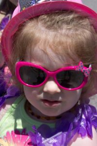 young girl in sunglasses at 3rd annual community celebration