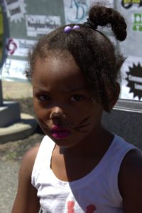 young girl with cat face paint at 3rd annual community celebration