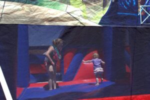 young kids in bounce house at 3rd annual community celebration