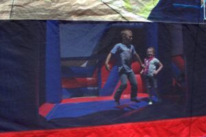 young kids in bounce house at 3rd annual community celebration