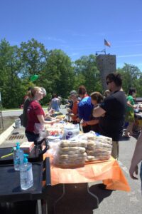 people handing out food at 3rd annual community celebration