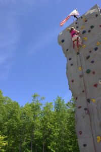 girl on climbing wall at 3rd annual community celebration