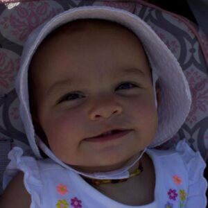 baby in bonnet at 3rd annual community celebration