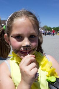 young girl in face paint at 3rd annual community celebration