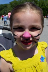 young girl in face paint at 3rd annual community celebration