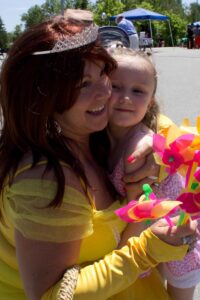 belle and young girl at 3rd annual community celebration