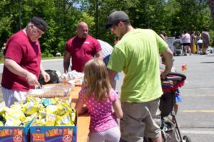 family getting some snacks at 3rd annual community celebration