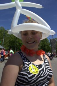 girl in balloon hat at 3rd annual community celebration