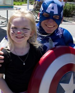 captain america and young girl at 3rd annual community celebration