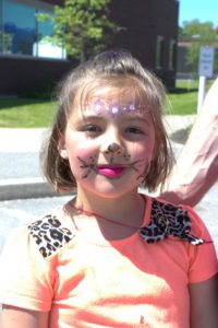 girl in cat face paint at 3rd annual community celebration
