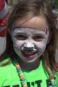 girl with cat face paint at 3rd annual community celebration