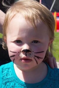 little girl with cat face paint at 3rd annual community celebration